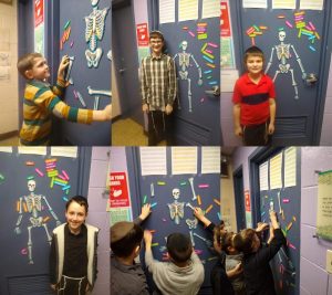 Boys completing the large "Build the Body" puzzle in the hall. In a fun manner, the boys are learning the names and locations of the bones in the human skeleton.